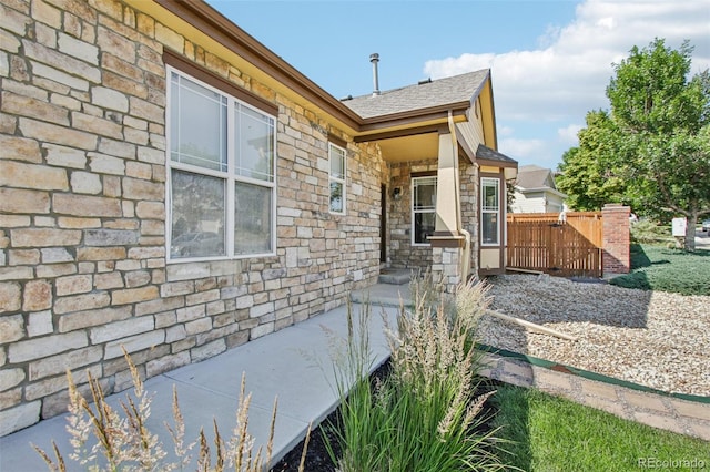 19677 E Vassar Dr, Aurora, CO 80013 - view of property exterior with stone siding and roof with shingles