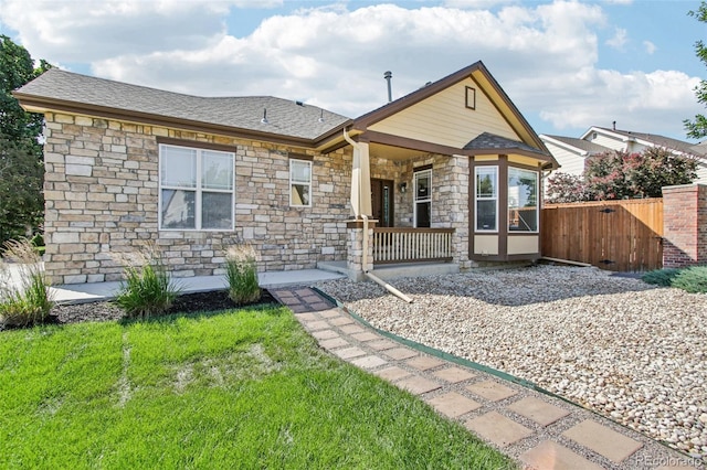 19677 E Vassar Dr, Aurora, CO 80013 - view of front facade featuring stone siding, a porch, and a shingled roof