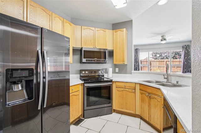 19677 E Vassar Dr, Aurora, CO 80013 - kitchen with stainless steel appliances, light countertops, light tile patterned floors, ceiling fan, and light brown cabinets