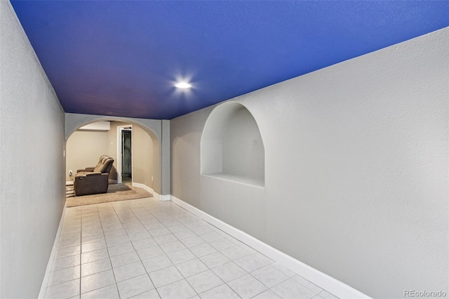19677 E Vassar Dr, Aurora, CO 80013 - hallway featuring arched walkways and light tile patterned flooring