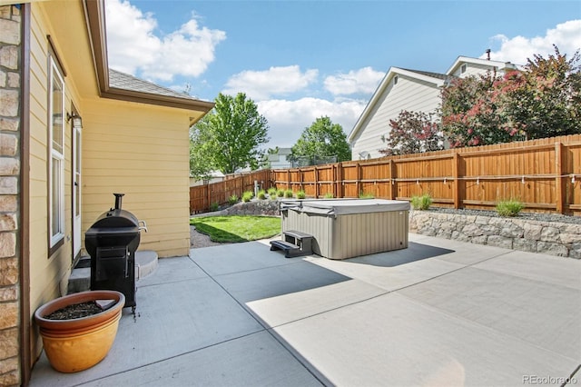 19677 E Vassar Dr, Aurora, CO 80013 - fenced backyard with a hot tub, a patio, and a grill