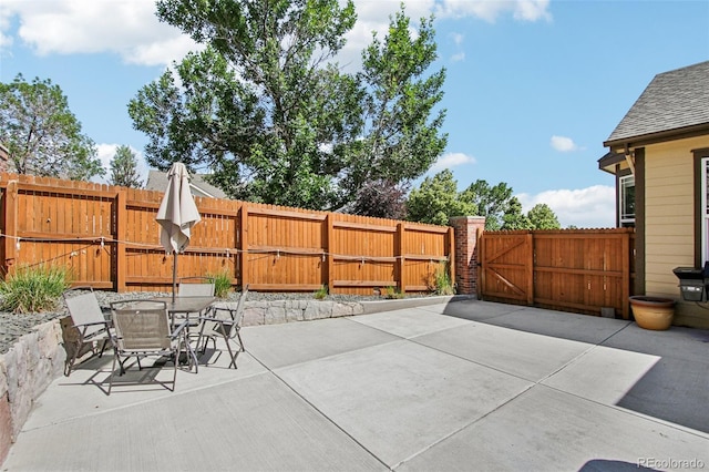 19677 E Vassar Dr, Aurora, CO 80013 - view of patio / terrace with a gate and outdoor dining space