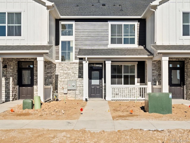 view of front of property featuring board and batten siding and a shingled roof