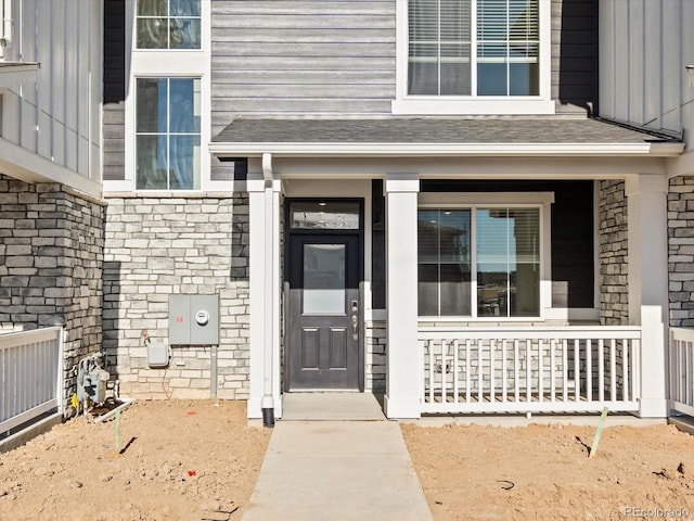 view of exterior entry with a porch