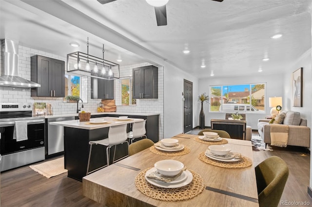 dining area with ceiling fan, dark hardwood / wood-style floors, and plenty of natural light