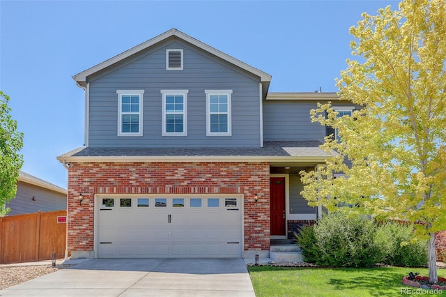 front facade featuring a front lawn and a garage