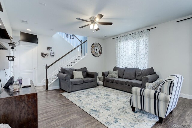 living room featuring ceiling fan and hardwood / wood-style floors