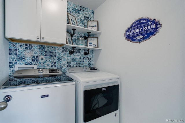 laundry area with cabinets and washing machine and clothes dryer