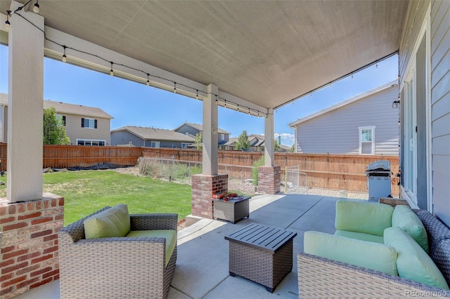 view of patio with an outdoor living space and a grill