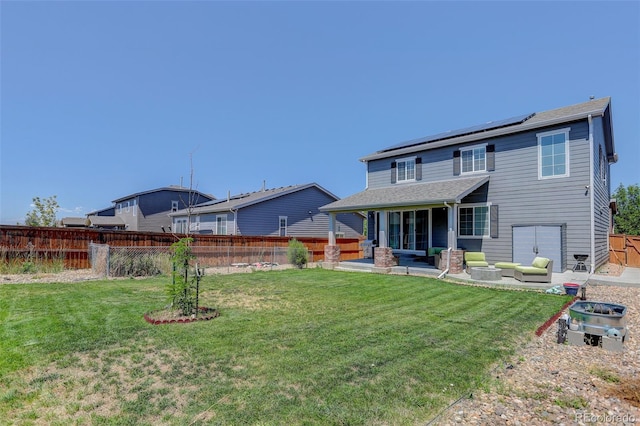 rear view of property with solar panels, an outdoor living space, a patio area, and a lawn