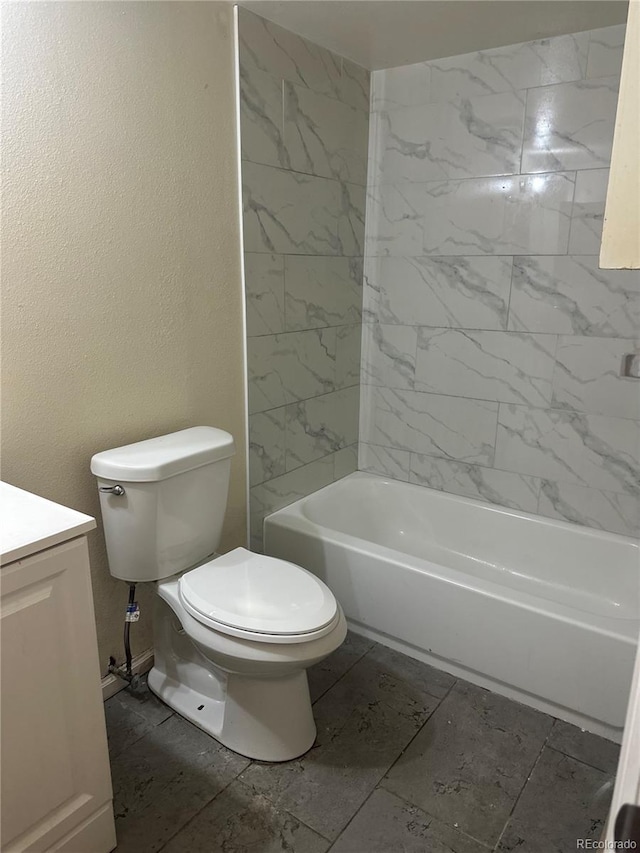 bathroom with washtub / shower combination, toilet, and vanity