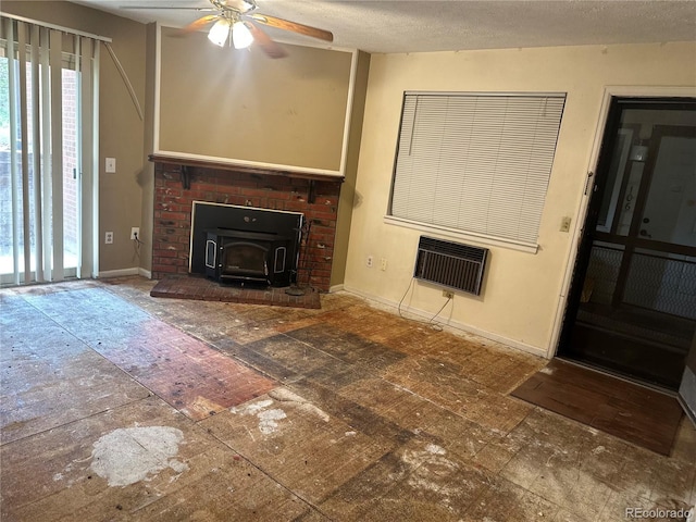 unfurnished living room with a wood stove, heating unit, baseboards, and ceiling fan