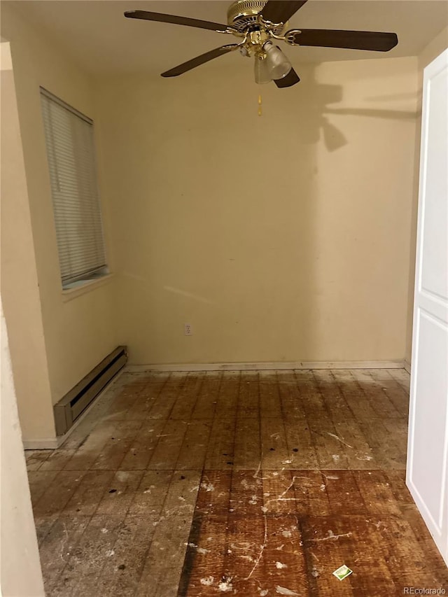 spare room with a ceiling fan and baseboard heating