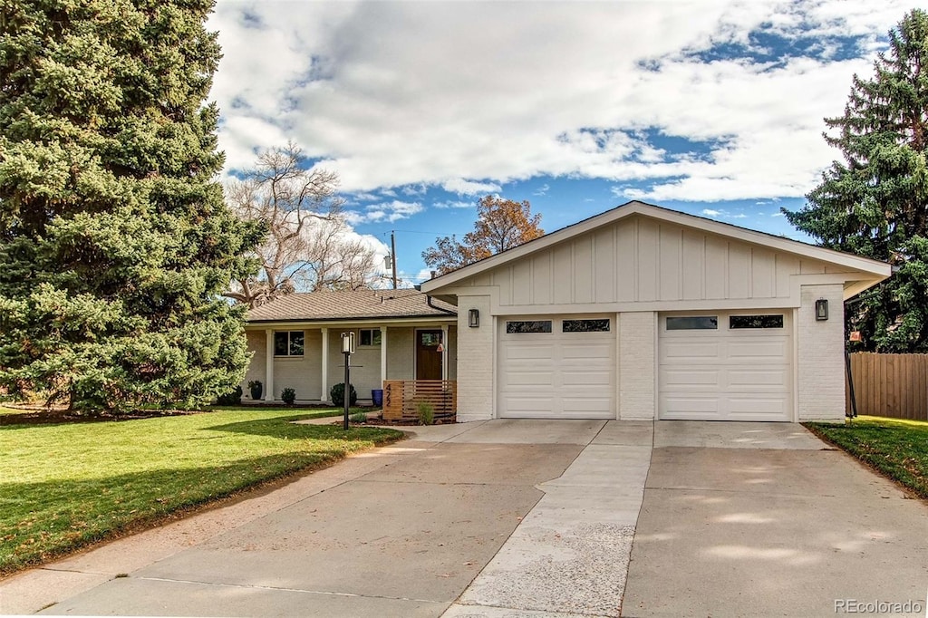 ranch-style house with a garage and a front lawn