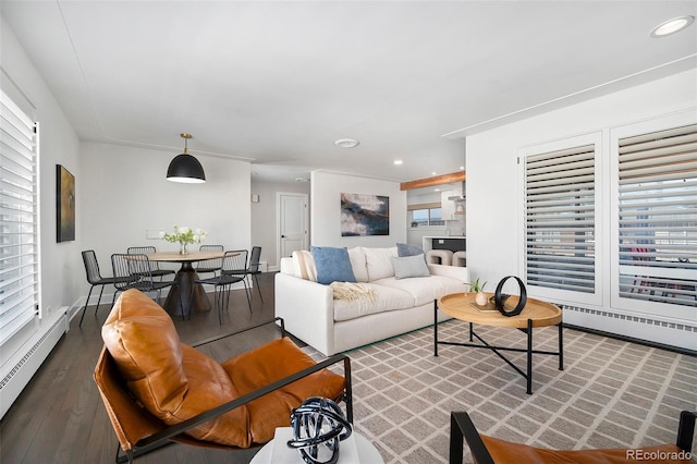 living room featuring a baseboard radiator, baseboards, recessed lighting, and wood finished floors