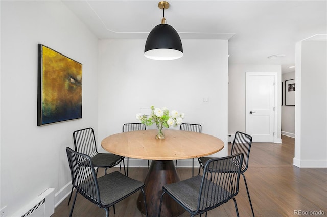 dining area featuring dark wood-style floors, baseboards, and baseboard heating