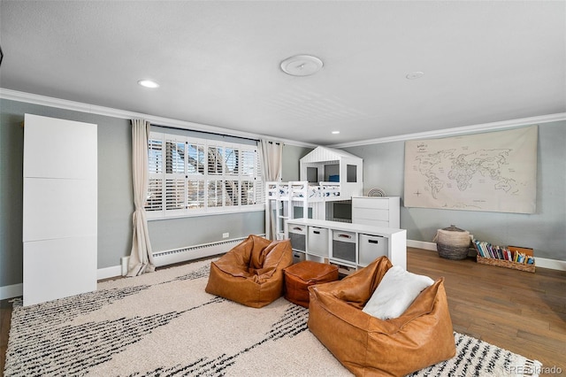 sitting room with recessed lighting, wood finished floors, baseboards, baseboard heating, and crown molding