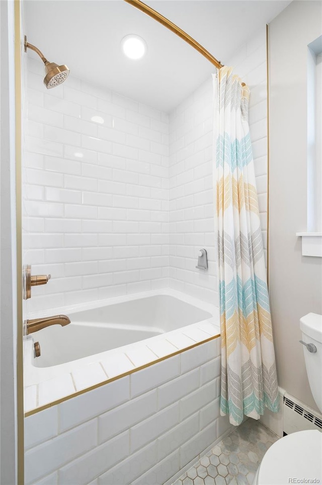 full bath with tiled shower / bath combo, baseboard heating, toilet, and tile patterned floors