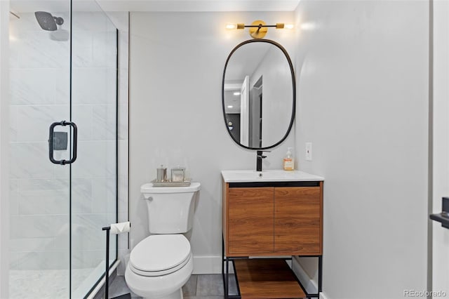 full bathroom featuring toilet, a shower stall, baseboards, and vanity