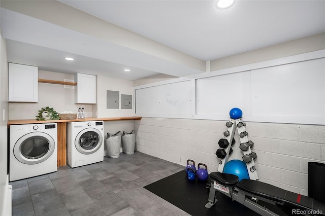 laundry area with recessed lighting, laundry area, electric panel, washer and clothes dryer, and concrete block wall