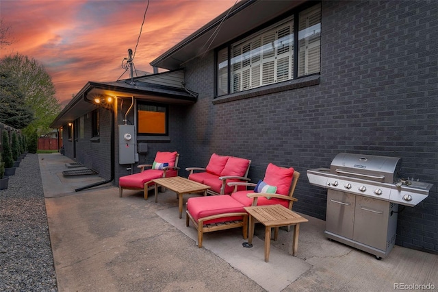 view of patio with outdoor lounge area, grilling area, and fence