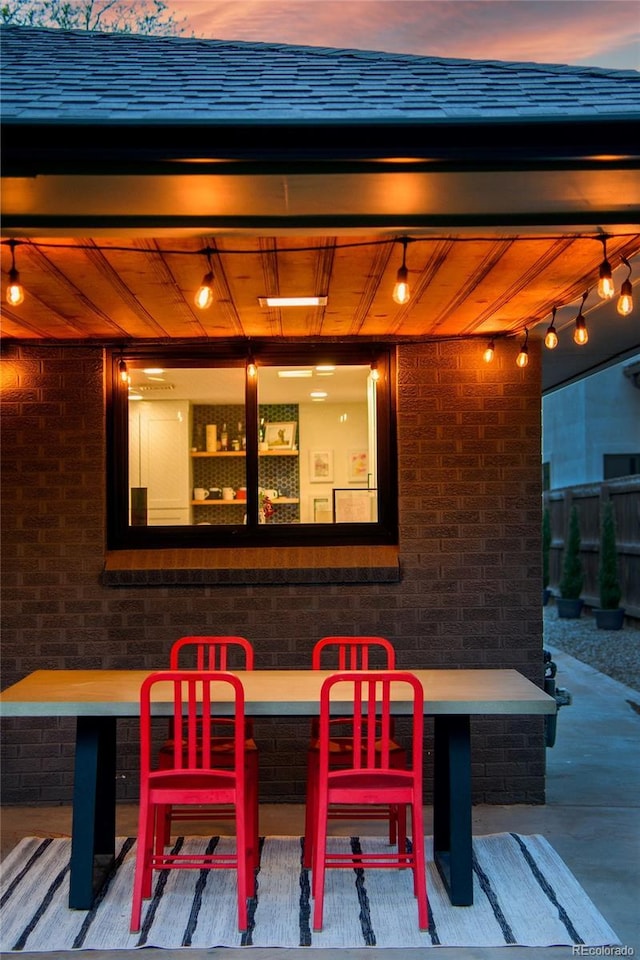 patio terrace at dusk featuring outdoor dining area