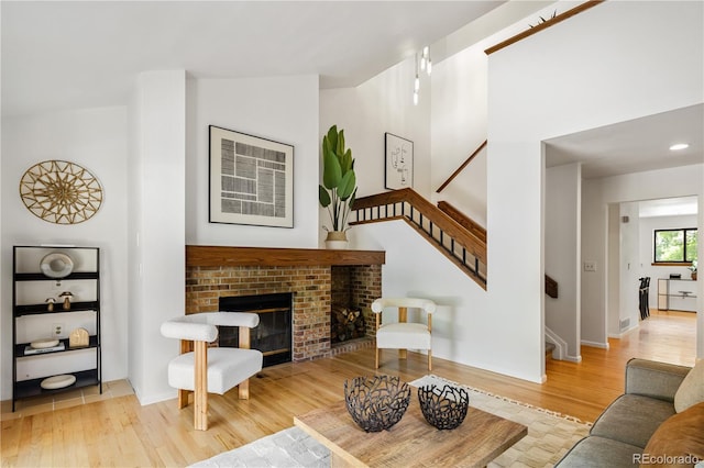 9400 E Iliff Ave Unit 292, Denver, CO 80231 - living area with wood finished floors, stairway, and a brick fireplace