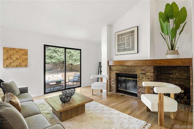 9400 E Iliff Ave Unit 292, Denver, CO 80231 - living room with a brick fireplace and light wood finished floors
