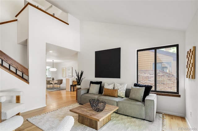 9400 E Iliff Ave Unit 292, Denver, CO 80231 - living room with light wood-style flooring, stairway, and high vaulted ceiling