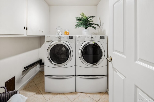 9400 E Iliff Ave Unit 292, Denver, CO 80231 - washroom featuring cabinet space, light tile patterned floors, and washing machine and clothes dryer
