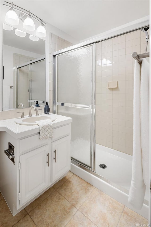 9400 E Iliff Ave Unit 292, Denver, CO 80231 - bathroom featuring vanity, a stall shower, and tile patterned floors
