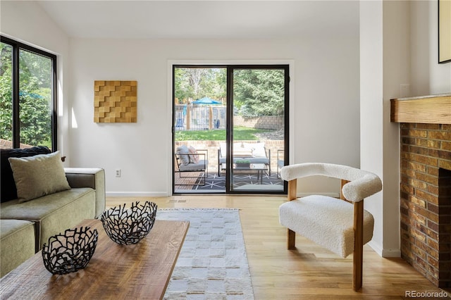9400 E Iliff Ave Unit 292, Denver, CO 80231 - living room with plenty of natural light, light wood finished floors, and a fireplace