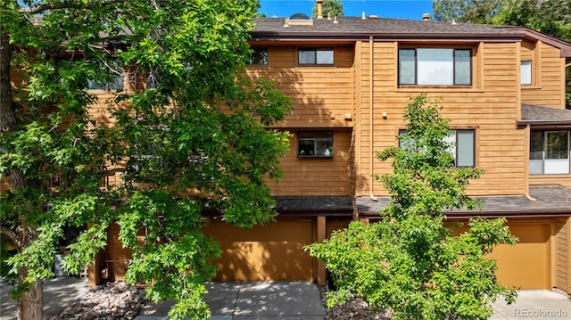 9400 E Iliff Ave Unit 292, Denver, CO 80231 - view of building exterior with driveway and an attached garage