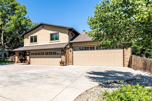 6740 S Windermere St, Littleton, CO 80120 - view of front of home with concrete driveway, brick siding, stucco siding, and a chimney