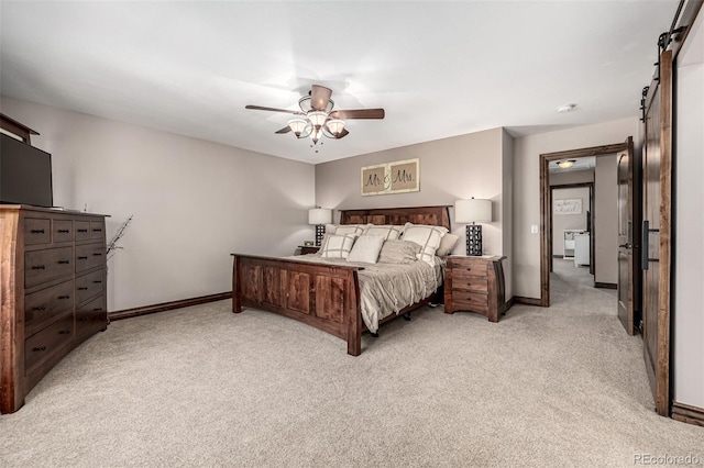 6740 S Windermere St, Littleton, CO 80120 - bedroom with a barn door, light colored carpet, baseboards, and a ceiling fan