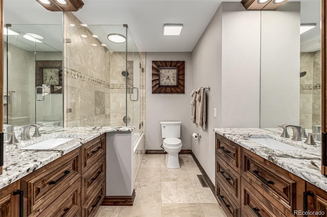 6740 S Windermere St, Littleton, CO 80120 - bathroom featuring two vanities, toilet, and baseboards