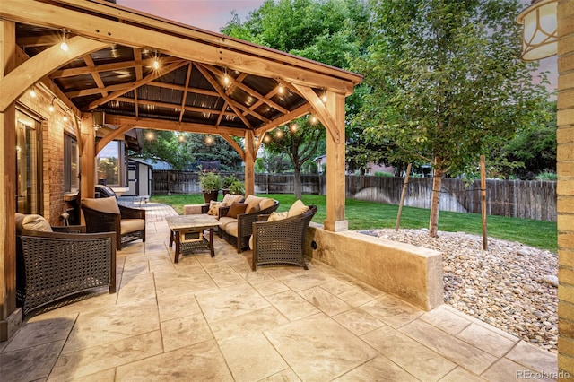 6740 S Windermere St, Littleton, CO 80120 - patio terrace at dusk featuring an outdoor hangout area, a patio area, and a gazebo