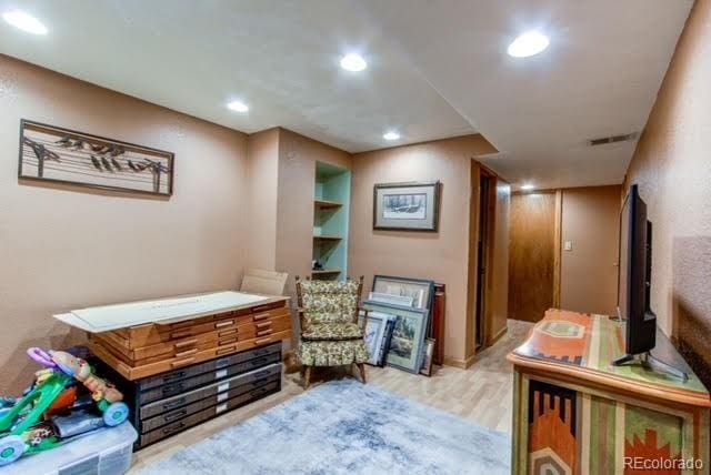 interior space with wood finished floors, visible vents, and recessed lighting