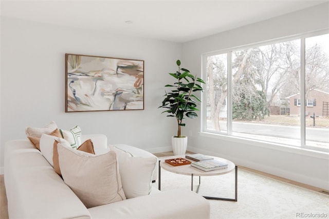 living room featuring a wealth of natural light, visible vents, and baseboards