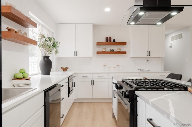 kitchen with extractor fan, light countertops, black appliances, white cabinetry, and open shelves