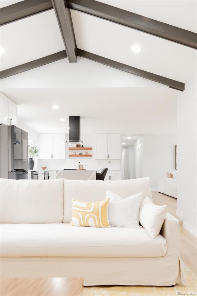 living area featuring lofted ceiling with beams and recessed lighting