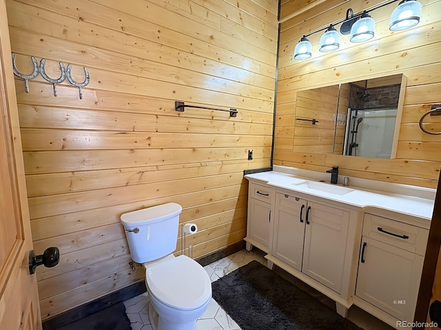 bathroom featuring toilet, wood walls, tile patterned flooring, and vanity
