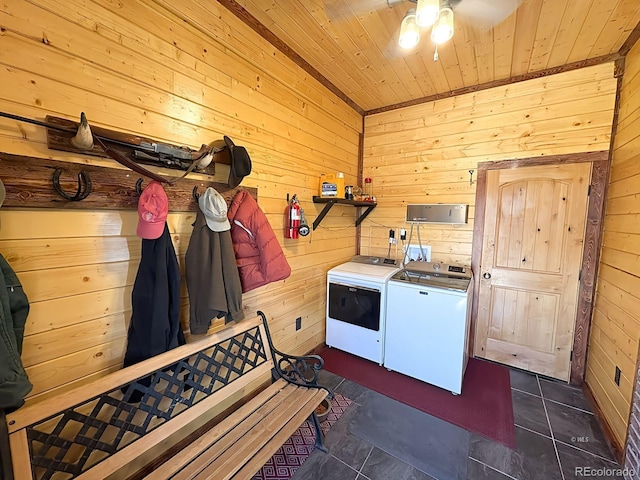 washroom with washing machine and clothes dryer, laundry area, ceiling fan, wooden ceiling, and wooden walls