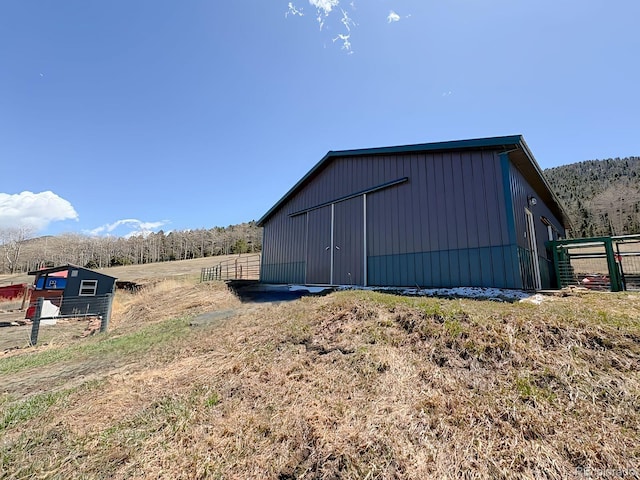 view of pole building featuring fence