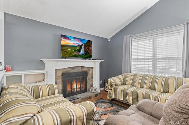 9648 Lane St, Thornton, CO 80260 - living area with vaulted ceiling, wood finished floors, and a glass covered fireplace