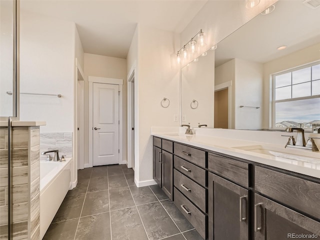 bathroom with tile patterned floors, vanity, and a bath