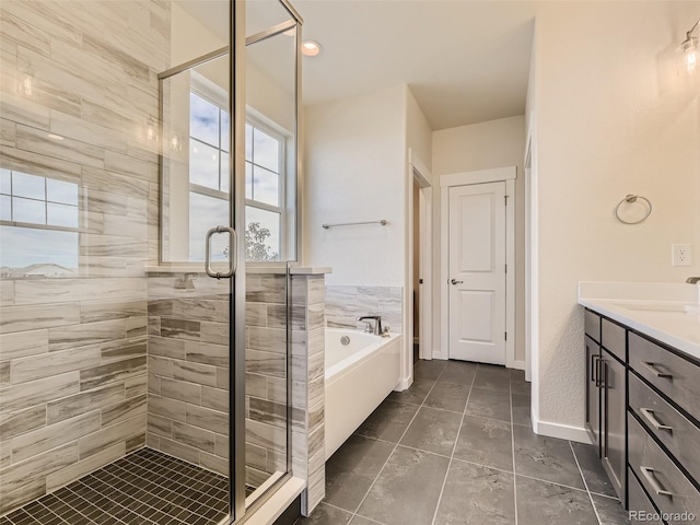 bathroom with tile patterned floors, vanity, and separate shower and tub