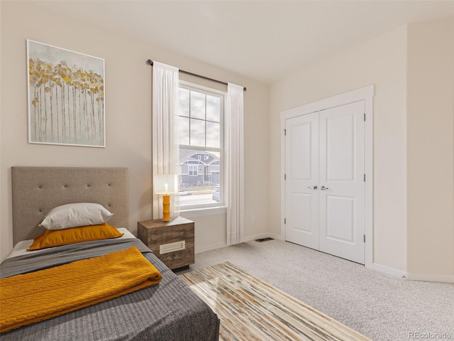 bedroom with carpet and a closet