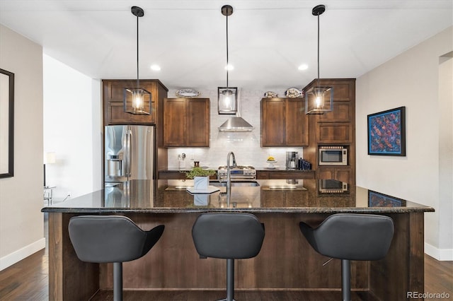 1882 W 67th Ave, Denver, CO 80221 - kitchen with stainless steel appliances, backsplash, a kitchen island with sink, dark wood-type flooring, and recessed lighting