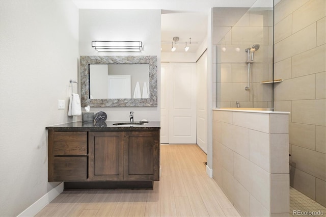 1882 W 67th Ave, Denver, CO 80221 - bathroom with walk in shower, vanity, and wood finished floors